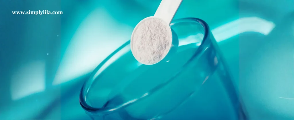 Close-up of a white powder supplement scoop over a clear glass against a teal blue background — electrolytes for water fasting hydration
