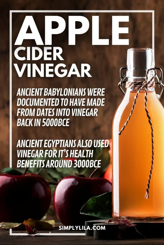 Rustic bottle of apple cider vinegar surrounded by fresh apples on a wooden table, illustrating the historical origins of vinegar use in Babylon and ancient Egypt, as featured on SimplyLila’s wellness blog.
