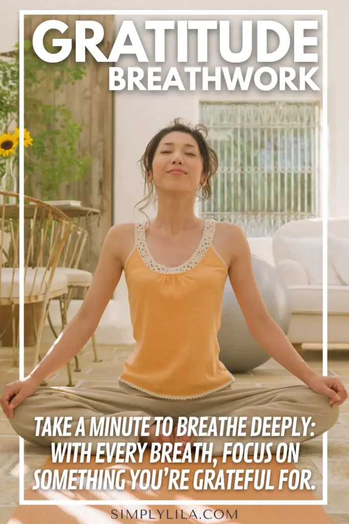 Woman practicing gratitude breathwork while sitting cross-legged indoors with eyes closed, sunlight streaming in, and text overlay reading “Take a minute to breathe deeply: With every breath, focus on something you’re grateful for,” promoting mindfulness and gratitude practice.