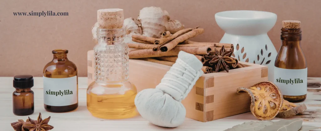 Amber essential oil bottles, cinnamon sticks, star anise, ginger root, herbal compress and ceramic oil burner on wooden surface