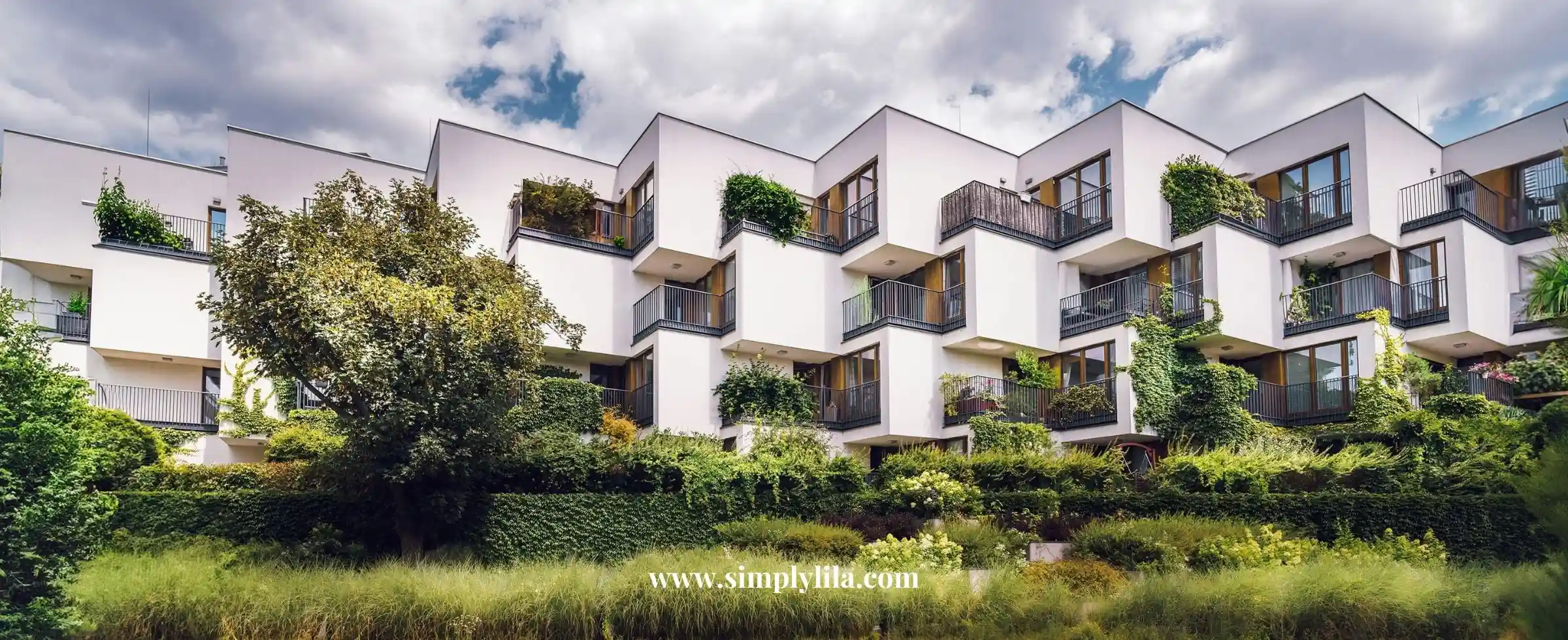 Modern eco-friendly apartment building with green balconies and vegetation